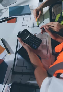 Two people working on a project with a calculator photo