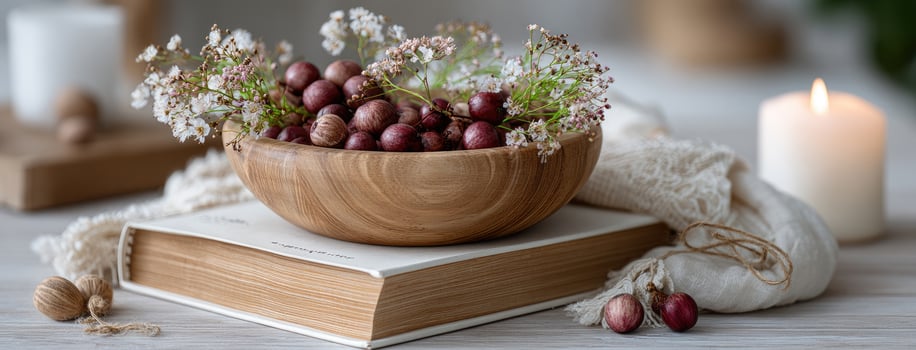 A bowl of dates and a book on a table photo
