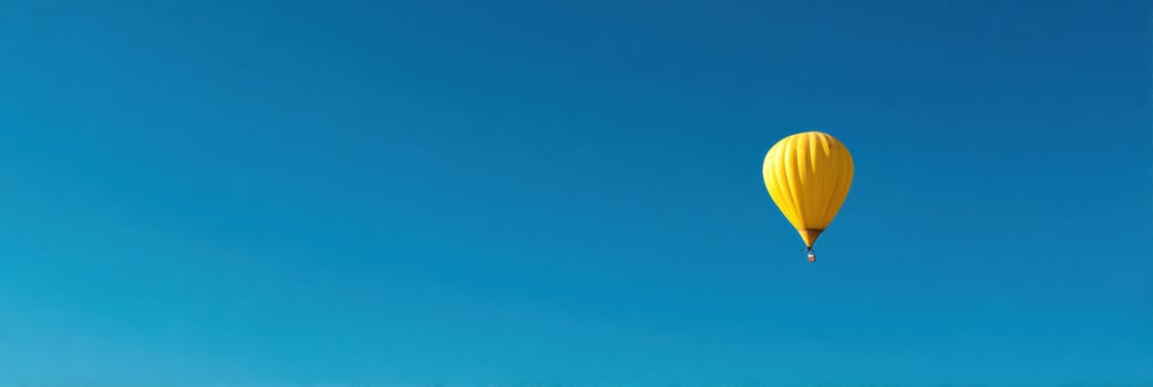 Surreal Hot Air Balloon Made of Banana Floating in a Clear Blue Sky With Ample Empty Space at the Top photo