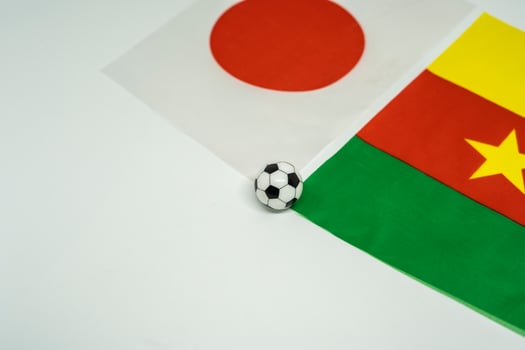 Football Clash. Japan vs Cameroon Featuring National Flags photo