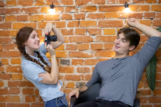 Girl photographer photographs a guy photo