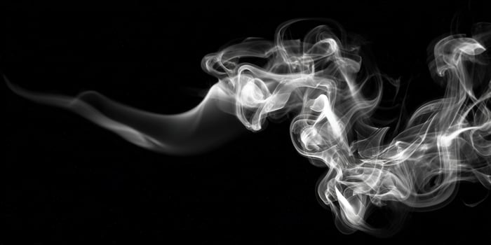 Elegant smoke gracefully swirls against a black backdrop, forming an artistic display of vapor and motion. photo