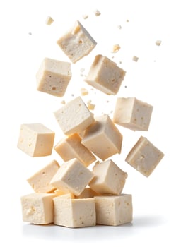 Fresh Tofu Cubes Falling and Stacking on a White Background 50 characters photo