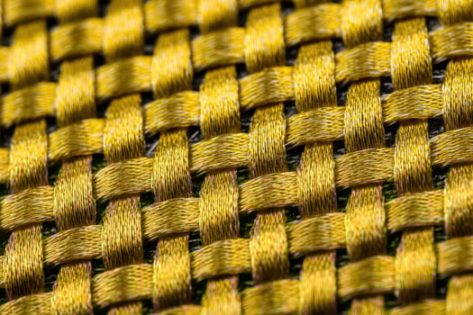 Close up view of woven Kevlar fabric showcasing intricate patterns and texture under natural light conditions photo