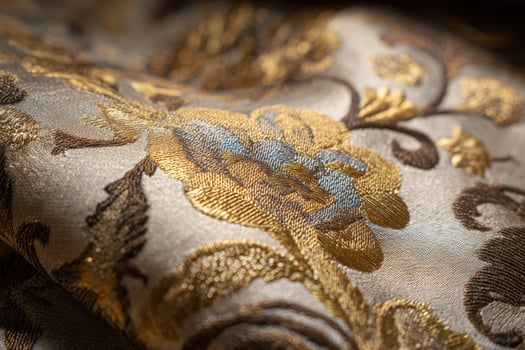 Elegant gold brocade fabric showcasing intricate floral patterns designed for luxurious textiles and decorative projects photo