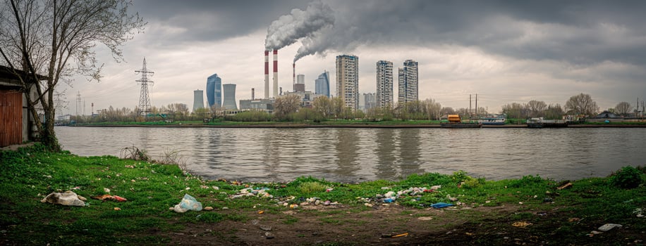 A river with trash and smoke coming out of the water photo