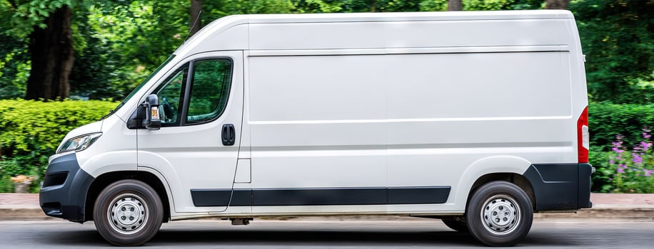 A white van is parked on the side of the road photo