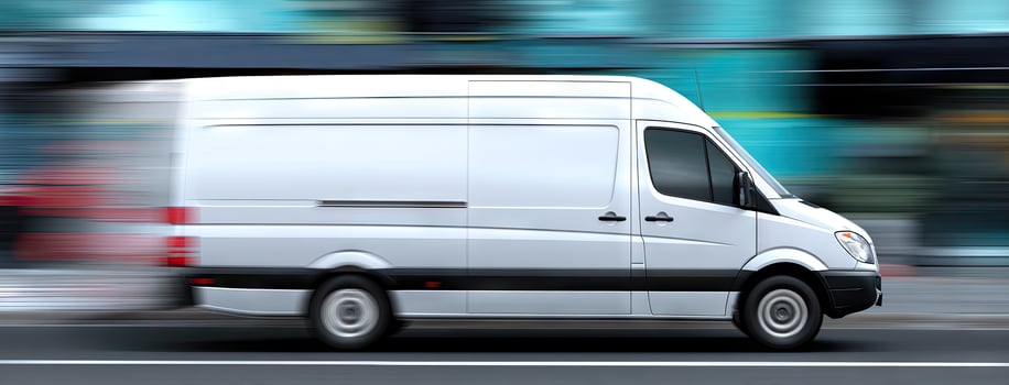A white van is driving down the street photo