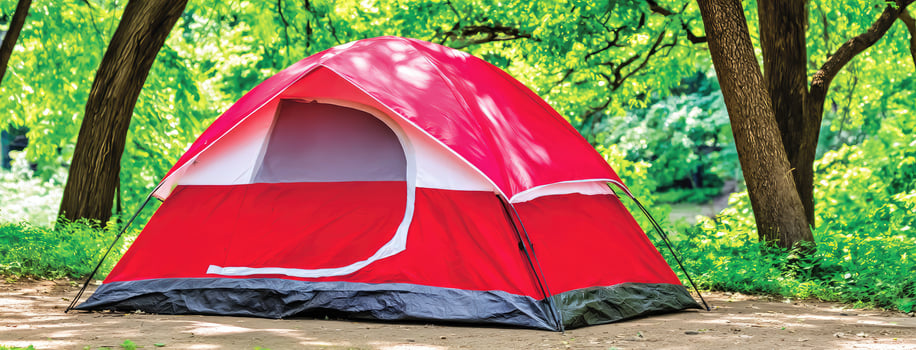 A red and white tent sitting in the woods photo