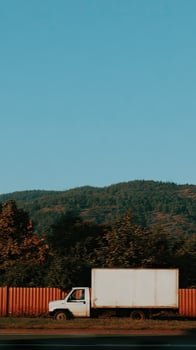 A white truck driving down the road photo