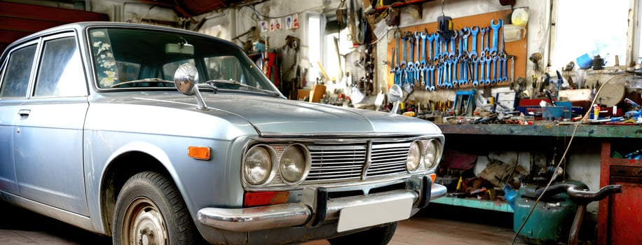 An old car is sitting in a garage photo