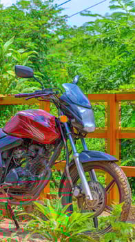 A red motorcycle parked on a dirt road photo