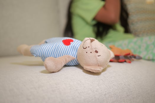Teddy bear lounging on a couch in a fun setting photo