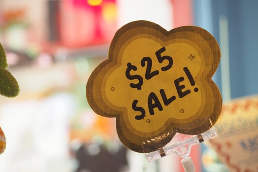 Sale sign displaying twenty-five dollar discount in store photo