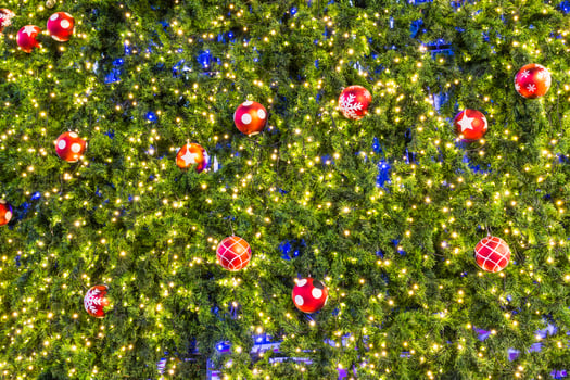 A large tree with many christmas balls hanging from it photo
