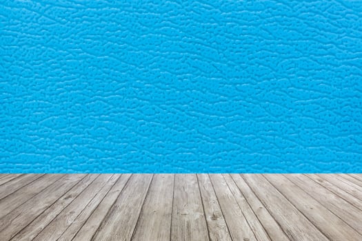 Wooden floor with blue leather wall background photo