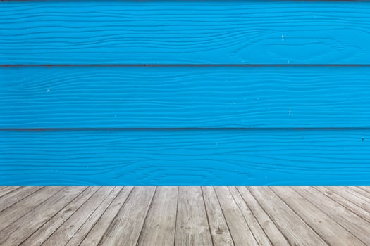 Wooden floor with blue wall background photo