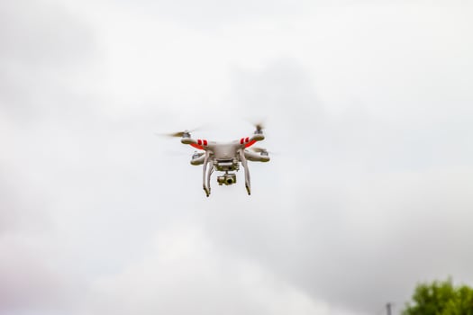 A small drone flying in the air photo