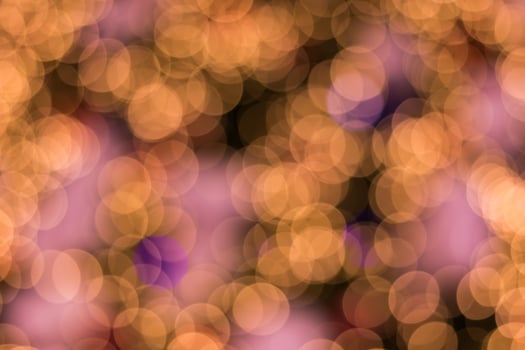 A blurry image of a purple and gold background photo
