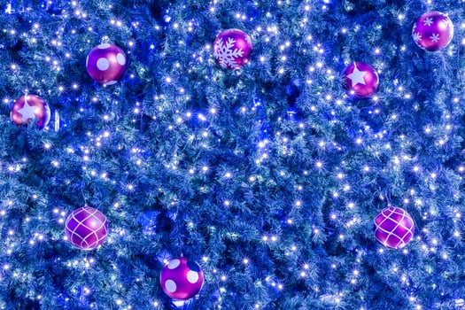 A christmas tree with many balls and lights photo