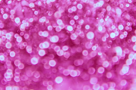 A pink background with many small bubbles photo