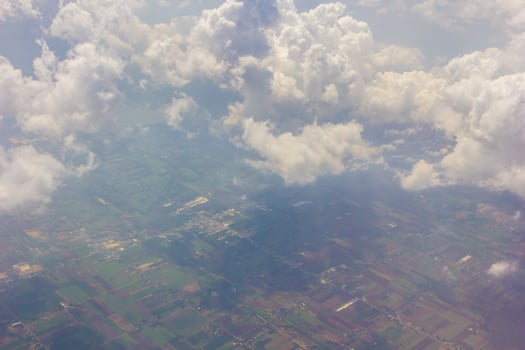 A view of a cloudy sky and a plane flying through it photo