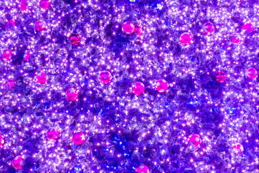 A purple christmas tree with many lights and balls photo
