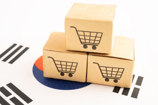 Box with shopping online cart logo and South Korea flag. photo