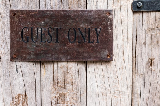 A sign on a wooden wall photo