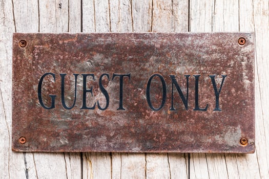 A sign that says guest only on a wooden wall photo