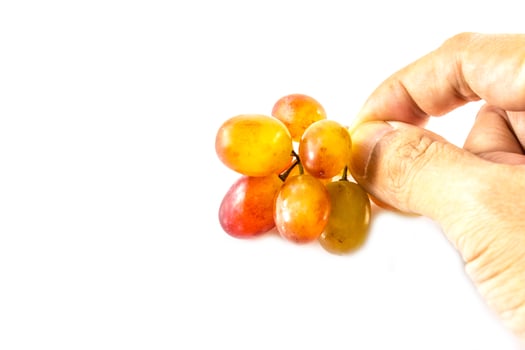A hand holding a bunch of grapes photo