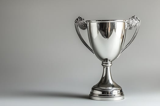 A Shiny Silver Trophy on a Neutral Background. A perfect image for celebrating success and achievement. photo
