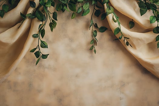 Elegant Beige Fabric Drape with Lush Greenery, Ideal for Product Displays or Backgrounds. photo