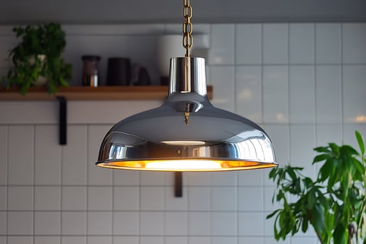 Stylish Chrome Pendant Light Fixture in Modern Kitchen Setting. A close-up image showcasing a contemporary light design. photo