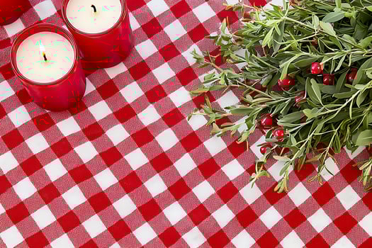 Festive Red and White Gingham Table Setting with Candles and Berries. A charming image perfect for holiday or seasonal designs. photo