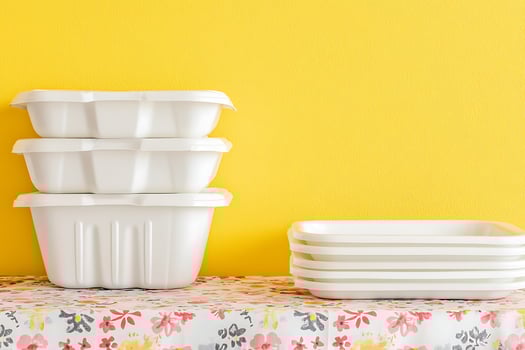 Stacked White Food Containers Against a Yellow Background. A clean and minimalist image of reusable food storage containers. photo