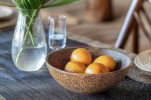 Sunlit Oranges in a Decorative Bowl on a Tabletop. A Still Life Image of Fresh Citrus Fruit. photo