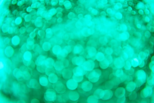 A green and blue background with a blurry image of a green ball photo