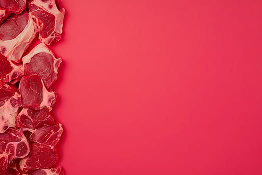 Raw Beef Steaks on Vibrant Red Background Culinary Image with Copy Space. photo