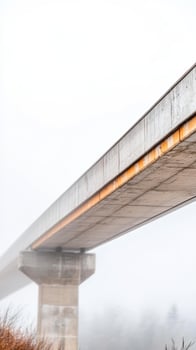 Concrete Bridge Structure Disappearing in Dense Fog A Moody Architectural Landscape. Elevated Pathway with Industrial Aesthetic photo