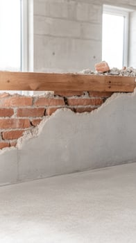 Close-up of a building under construction, showcasing exposed brickwork, textured concrete, and wooden beams. Architectural renovation in progress. photo