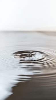 Mesmerizing Water Ripple A Captivating Close-Up of a Single Drop Creating Perfect Concentric Waves on a Serene Liquid Surface, Evoking Calm. photo