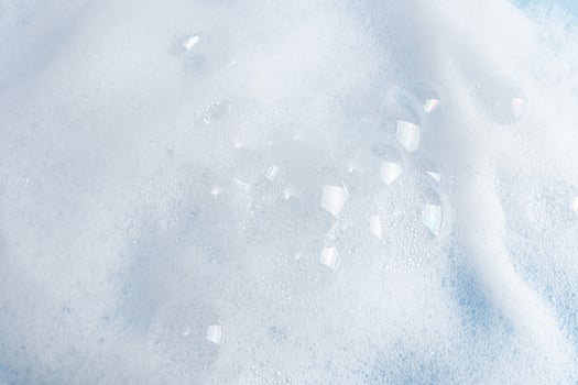 Chic foamy surface of liquid soap, gel, washing powder with bubbles. A copy of the space. Mockup for Spa Cosmetics Product, Detergents. photo