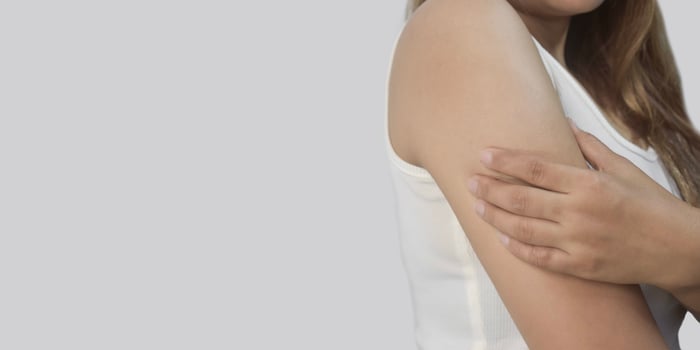Asian Young Woman Experiencing Arm Pain photo