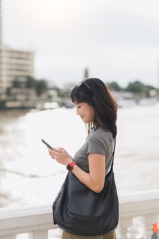 Young southeast asian woman teenager blogger searching map smartphone for local travel guide. world explorer tourism concept for cultural experience Bangkok Thailand by Chao Phraya river Asia photo