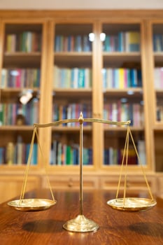 Golden Scale in vintage mood and tone lays on wooden table in front of wood library in Asia.aa photo
