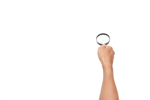 Hand holding magnifying glass on white background, symbolizing search and investigation photo