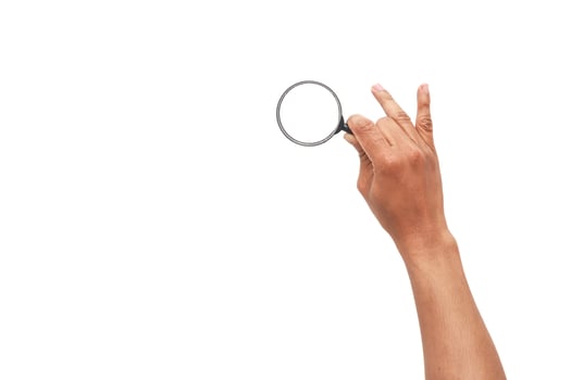 A hand holding a magnifying glass against a bright, clean white backdrop for graphic use photo
