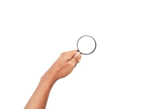 A hand holds a magnifying glass against a clean white background providing space for text photo