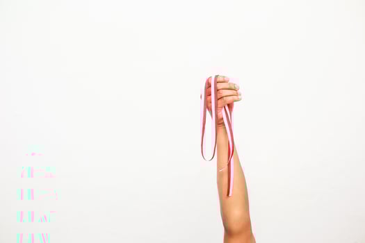 A hand holding a red and white ribbon, symbolising Indonesian Independence Day celebration photo